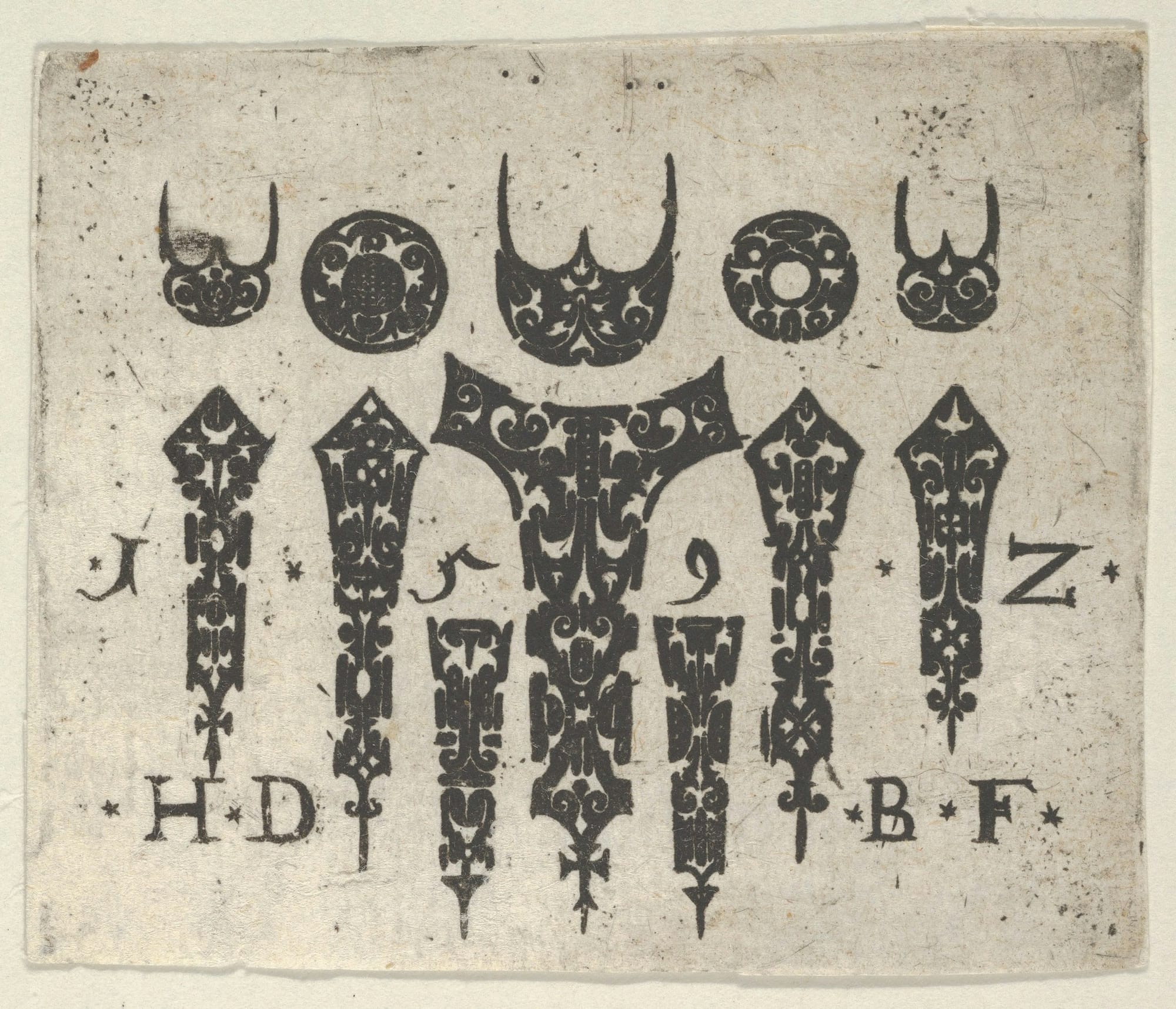 A black and white antique print of decorative shapes and letters
